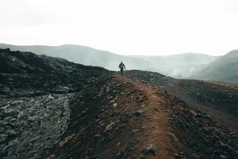 a person standing on top of a dirt hill