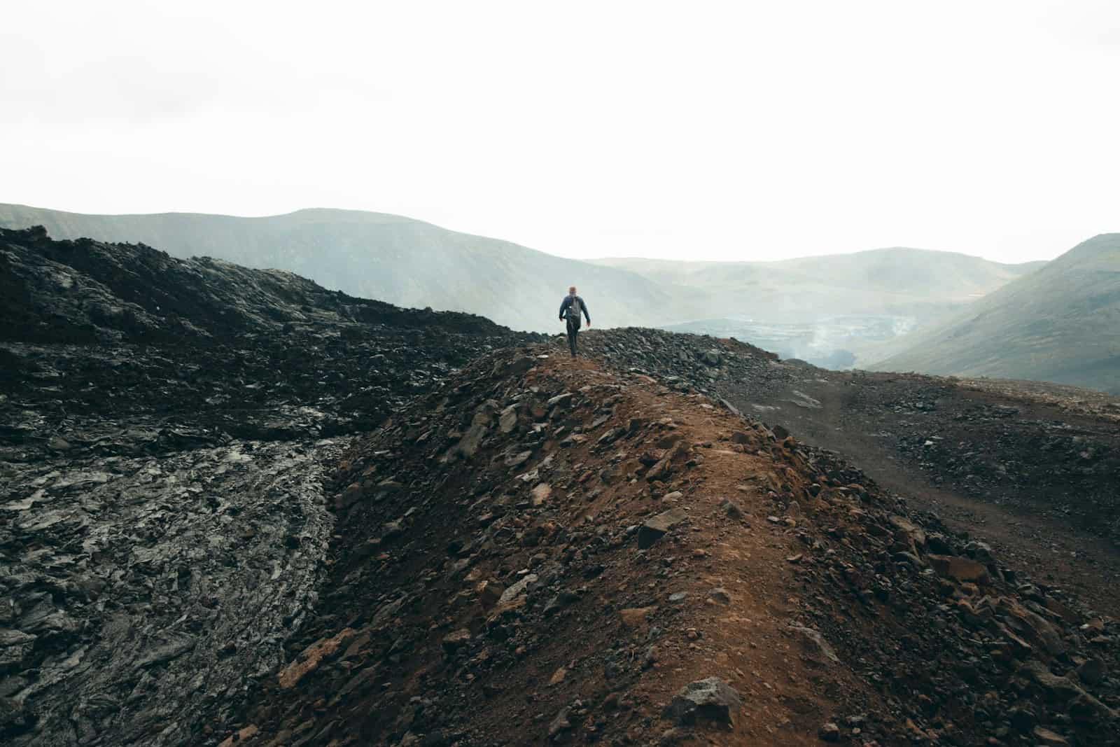 a person standing on top of a dirt hill